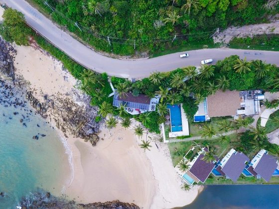 Aerial view of a beachfront land and villas