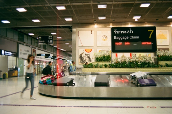 None Woman walking past baggage claim belt in an airport